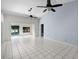 Open living room boasts tile floors, ceiling fans and natural light from sliding glass doors at 2726 La Alameda Ave, Kissimmee, FL 34746
