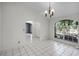 A vacant living room showcases tile flooring, archways, and large picture window at 2726 La Alameda Ave, Kissimmee, FL 34746