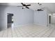 Comfortable living area with tiled floors and ample natural light, ceiling fans, and neutral colors at 2726 La Alameda Ave, Kissimmee, FL 34746