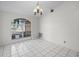 This empty living room features tile floors, a window, and ornate lighting fixture at 2726 La Alameda Ave, Kissimmee, FL 34746