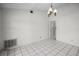 This is an empty living room with tile flooring and a hanging light at 2726 La Alameda Ave, Kissimmee, FL 34746