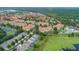Expansive aerial view of a residential community with pools, water features, and lush greenery at 2785 Almaton Loop # 202, Kissimmee, FL 34747