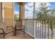 Relaxing balcony view with seating and screened enclosure, perfect for enjoying the outdoors at 2785 Almaton Loop # 202, Kissimmee, FL 34747