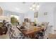 Inviting dining area with elegant furnishings, modern chandelier, and sliding glass door to patio at 2785 Almaton Loop # 202, Kissimmee, FL 34747