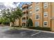 Well-maintained condo building featuring multiple screened patios, professional landscaping, and ample parking at 2785 Almaton Loop # 202, Kissimmee, FL 34747