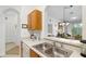 Bright kitchen showcasing stainless sink, modern appliances, and seamless flow to living area at 2785 Almaton Loop # 202, Kissimmee, FL 34747