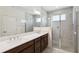 Luxurious bathroom featuring a double vanity, tiled shower, and modern fixtures at 3128 Oxbow Ct, Harmony, FL 34773