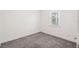 Bedroom features neutral carpet, white walls and baseboards, and a window at 3128 Oxbow Ct, Harmony, FL 34773