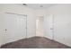 Bedroom with neutral carpet and closet featuring sliding doors at 3128 Oxbow Ct, Harmony, FL 34773
