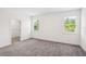 Cozy bedroom featuring plush carpeting, neutral walls, and two windows offering natural light at 3128 Oxbow Ct, Harmony, FL 34773