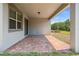 Enjoy the outdoor living space on the brick-paved covered patio with a view of the expansive backyard at 3128 Oxbow Ct, Harmony, FL 34773