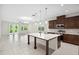 Open-concept kitchen and living area featuring a large island with quartz countertops and stainless steel appliances at 3128 Oxbow Ct, Harmony, FL 34773