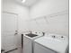 Laundry room featuring modern washer and dryer with a utility sink at 3128 Oxbow Ct, Harmony, FL 34773