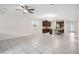 Open-concept living area with tile floors, view of kitchen, and a modern ceiling fan at 3128 Oxbow Ct, Harmony, FL 34773