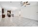 Spacious living area with tile flooring, open layout to the kitchen, and a modern ceiling fan at 3128 Oxbow Ct, Harmony, FL 34773