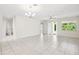 Bright, open living area with neutral walls, tile floors, and large windows offering outdoor views at 3128 Oxbow Ct, Harmony, FL 34773
