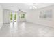 Bright, open living area with tile flooring, neutral walls, and sliding glass doors to the backyard at 3128 Oxbow Ct, Harmony, FL 34773