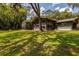 Back exterior of home with screened in enclosure and large backyard at 3359 Scarlet Dr, Sanford, FL 32773