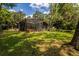 Rear exterior view of the home featuring a spacious screened enclosure and lush backyard at 3359 Scarlet Dr, Sanford, FL 32773