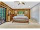 Cozy bedroom with wood paneling, dresser, and glass patio door, offering natural light at 3359 Scarlet Dr, Sanford, FL 32773
