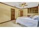 Bedroom with neutral carpet, ceiling fan, and calming neutral color scheme and wood accents at 3359 Scarlet Dr, Sanford, FL 32773