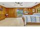 Bedroom with wood paneling and sliding glass doors lead to a beautiful backyard oasis at 3359 Scarlet Dr, Sanford, FL 32773