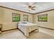 Bright bedroom with neutral carpet, ceiling fan, and calming neutral color scheme at 3359 Scarlet Dr, Sanford, FL 32773