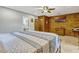 Bedroom with wood paneling features a TV, dresser, ensuite bath, and closet at 3359 Scarlet Dr, Sanford, FL 32773