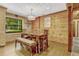 Cozy dining room featuring wood paneled walls, a large window, and a rustic dining set at 3359 Scarlet Dr, Sanford, FL 32773