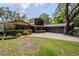 Charming home featuring a large, bright window, mature trees, and a spacious driveway at 3359 Scarlet Dr, Sanford, FL 32773
