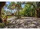 Home exterior featuring mature trees, covered parking, and a large yard at 3359 Scarlet Dr, Sanford, FL 32773