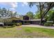 Charming home featuring a large, bright window, mature trees, and a spacious driveway at 3359 Scarlet Dr, Sanford, FL 32773