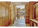 Inviting foyer showcasing wood paneled walls, stone floors, and a glimpse into the open living area at 3359 Scarlet Dr, Sanford, FL 32773
