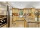 Bright kitchen featuring stainless steel appliances and light wood cabinets at 3359 Scarlet Dr, Sanford, FL 32773