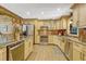 Spacious kitchen with stainless steel appliances, light wood cabinets, and wood flooring at 3359 Scarlet Dr, Sanford, FL 32773