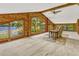 Bright living room boasts lake views through expansive windows and wood paneled walls at 3359 Scarlet Dr, Sanford, FL 32773