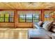 Bright living room with hardwood floors, wood-paneled walls and views of the lake at 3359 Scarlet Dr, Sanford, FL 32773