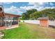 Backyard featuring a cozy patio, well-maintained grass, and a shed at 4051 Eagle Feather Dr, Orlando, FL 32829
