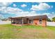Backyard featuring a cozy patio, well-maintained grass, and a shed at 4051 Eagle Feather Dr, Orlando, FL 32829