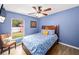 Cozy bedroom featuring a window view to the backyard and a wooden-framed bed at 4051 Eagle Feather Dr, Orlando, FL 32829