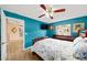 Bright blue bedroom featuring a window, a ceiling fan and light-colored wood-look flooring at 4051 Eagle Feather Dr, Orlando, FL 32829