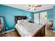 Cozy bedroom showcasing a large bed, stylish decor, and serene ambiance with light-colored floors at 4051 Eagle Feather Dr, Orlando, FL 32829
