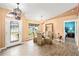 The dining room features wood-look tile floors, bright paint, modern lighting, and backyard views at 4051 Eagle Feather Dr, Orlando, FL 32829