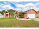 Inviting single-Gathering home featuring manicured lawn, lovely landscape, and a convenient two-car garage at 4051 Eagle Feather Dr, Orlando, FL 32829