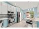 Stylish kitchen with stainless steel appliances, modern cabinets, eat in breakfast nook with backyard views at 4051 Eagle Feather Dr, Orlando, FL 32829