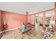 Cozy living room showcasing an open layout, wood-look floors, and seamless transition to dining area at 4051 Eagle Feather Dr, Orlando, FL 32829