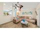 Open-concept living area with stylish decor, comfortable seating, and wood-look flooring throughout at 4051 Eagle Feather Dr, Orlando, FL 32829