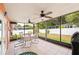 A relaxing patio with multiple ceiling fans and a round dining table with chairs at 4051 Eagle Feather Dr, Orlando, FL 32829