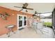 A relaxing patio with multiple ceiling fans and a round dining table with chairs at 4051 Eagle Feather Dr, Orlando, FL 32829