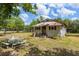 Exterior view of a single-story house with lawn and picnic table at 47730 State Road 19, Altoona, FL 32702